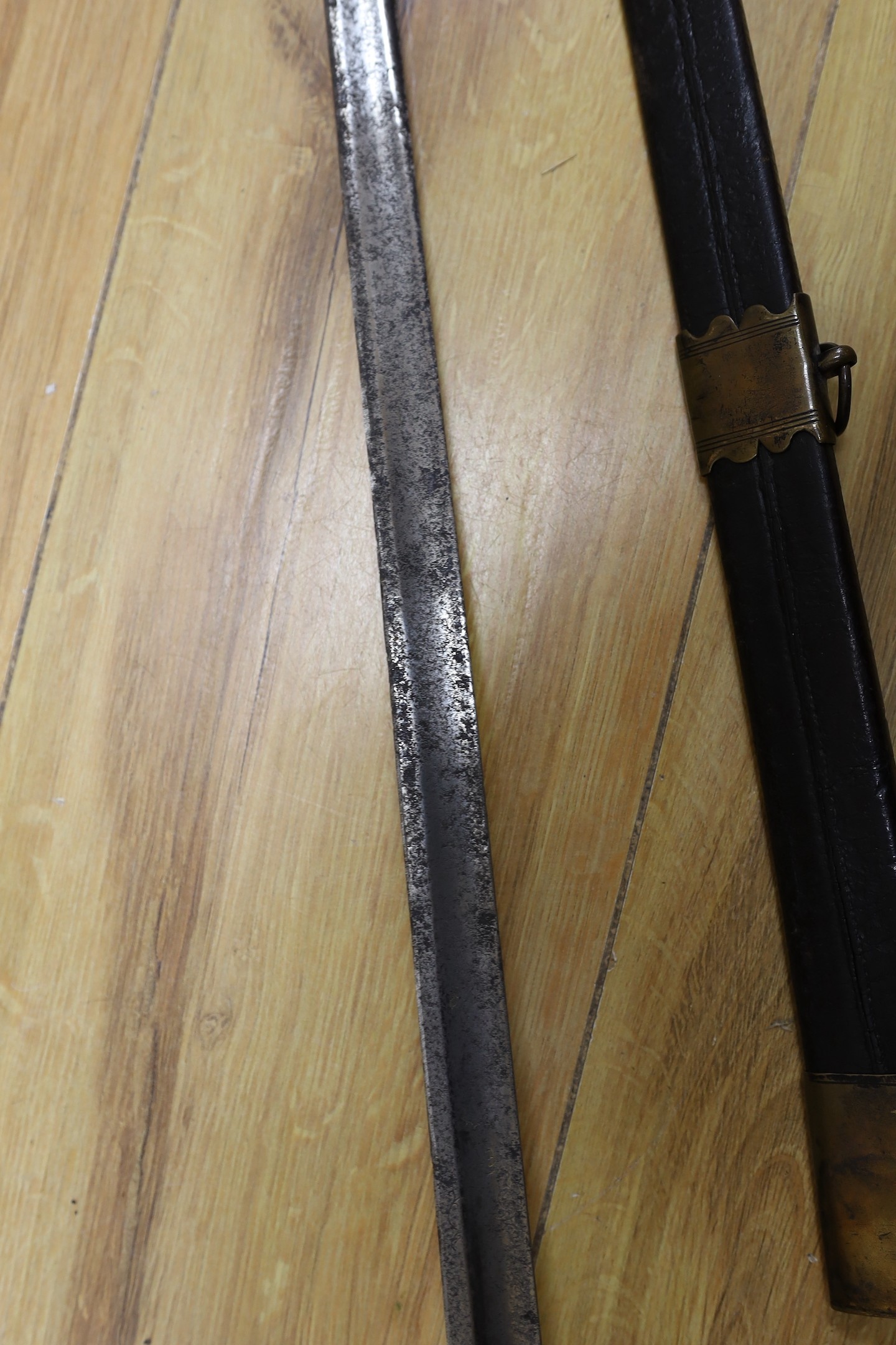 An 18th century European brass hilted sword and scabbard. 89cm long